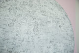 Close-up of the moon chart's intricate crater details and cartographic text on textured canvas.