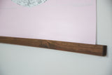 Rich grain of the handmade walnut wood display rod on the pink canvas art print.