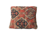 Storied antique Amu Darya pillow, intricate geometric patterns in red, black, and aubergine.