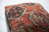 Intricate aubergine and red geometric pattern on antique Amu Darya rug fragment.