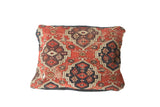Hand-knotted Antique Amu Darya fragment pillow, featuring storied red, black, and beige patterns.