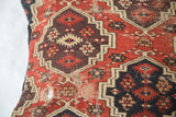 Geometric red, black, aubergine pattern on antique Amu Darya rug fragment, storied wear.