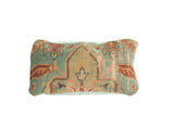 Antique Turkish rug fragment pillow displays a central mihrab motif in soft blues and pinks.
