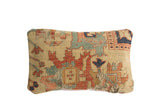 Antique Yellow Serapi rug fragment pillow with worn red, teal, and navy geometric patterns.