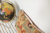 Side of antique Serapi rug fragment pillow, worn yellow with geometric patterns, pale peach linen back.