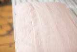 European linen pillow back in pale peach blush with envelope closure seam.