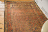 Distressed red and blue geometric field with secured side of an antique Kurdish rug.