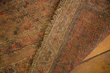 Secured side and distressed hand-knotted texture of an antique Kurdish rug, subdued colors.