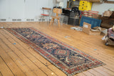 Antique Karaja runner featuring a distressed indigo field with madder root red geometric patterns.