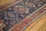 Distressed antique Karaja runner, featuring indigo geometric patterns and madder red tones.