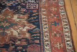 Distressed antique Karaja runner's indigo field with geometric shapes, madder red border, and textural wear.