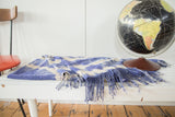 Hand woven blue and ivory pattern with long tassels on a vintage African textile throw.