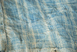 Intricate powder blue and ivory patterns on vintage hand woven African indigo textile.