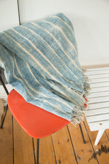 Fringed edge of the powder blue striped vintage African indigo textile.