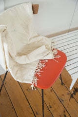 Short tassels and natural textured weave on the ivory hand-woven African throw.