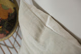 Textured edge of the sun-faded powder blue indigo pillow.