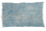 Hand-woven vintage African indigo textile throw, light and denim blue, with short tassels.