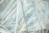 Panel stitching and varied light blue tones of the vintage hand-woven African textile.