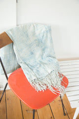 Textured weave and tassels of a powder blue hand woven African throw.