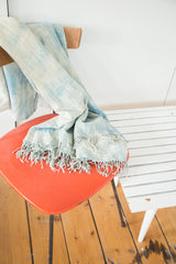 Textured ivory and light blue vintage African textile with fringed edge.