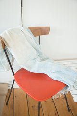 Ivory and powder blue African textile throw displaying soft weave and fringed edge.