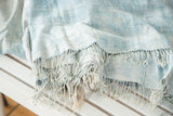 Hand-woven powder and light blue vintage African indigo textile with short tassels.