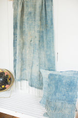 Vintage indigo wall hanging featuring sun-faded blue and raw textile texture.