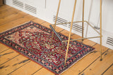 Full view of an antique Kerman rug's Tree of Life motif on a rich magenta field.
