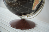 Vintage Rand McNally black globe's dark wood base, showing the Pacific Ocean and South America.