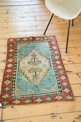 Antique Oushak rug with playful terracotta geometric border and vivid Caribbean blue field.