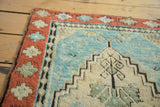 Antique Oushak rug corner showcases full pile, terracotta border and serene Caribbean blue field.