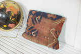 Antique hand-knotted Kazak fragment pillow, geometric design, faded turquoise linen back.