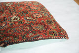 Side view: Antique Herati Bijar fragment pillow, rich red pattern, seafoam linen back.