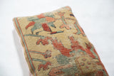 Antique Serapi rug fragment pillow detail, showing aged texture and yellow geometric pattern.