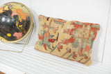 Antique Serapi pillow fragment showcasing its aged yellow pile and distinctive motifs.