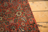 Intricate red, green, and blue floral motifs on the antique Bijar fragment pile.