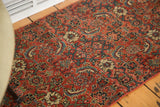 Intricate hand-knotted Bijar botanical pattern in bold red, teal, and cream tones.