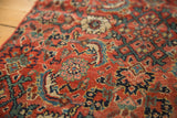 Intricate hand-knotted red, blue, and cream pattern on antique Bijar rug fragment pile.