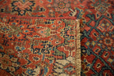 Antique Bijar fragment rug's intricate red and navy pattern where it meets the woven fringe.