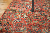 Intricate hand-knotted pattern of the antique Bijar rug with bold red and vibrant botanical motifs.