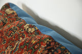 Late 19th century Persian Bijar rug fragment showing bold red, yellow, ivory, bordering blue canvas.