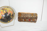 Vintage Caucasian rug fragment pillow with geometric floral motifs and tangerine velvet top.