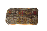 Vintage Floral Caucasian rug fragment pillow with geometric patterns, earthy tones, and tangerine orange velvet.