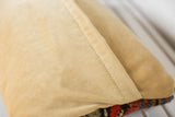 Soft gold velvet back of the Antique Kazak Rug Fragment Pillow with envelope stitching.
