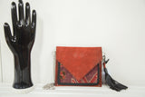 Red suede handmade purse with vintage Northwest Persian rug fragment in purple and red.