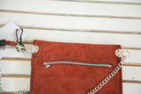 Reddish suede back of the handmade purse, with metal zipper and silver chain.