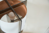 Reversible Tucker lamp shade showing white exterior, copper interior, dark acrylic supports.