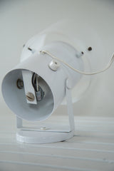 White vintage spotlight desk lamp interior with visible wires and bulb socket.
