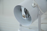 Vintage white spotlight lamp interior showing wiring and mounting screw.