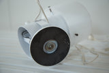 Bottom view of the vintage white desk lamp base, showing black pad and power cord.